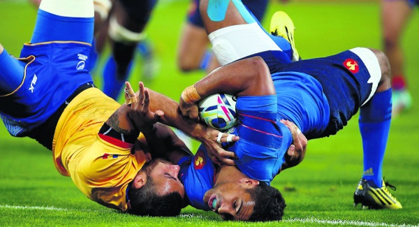 France centre Wesley Fofana scores his side's fourth try despite the best efforts of Romania's Madalin Lemnaru