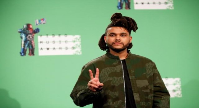 The Weeknd poses backstage during the 2015 MTV Video Music Awards in Los Angeles California