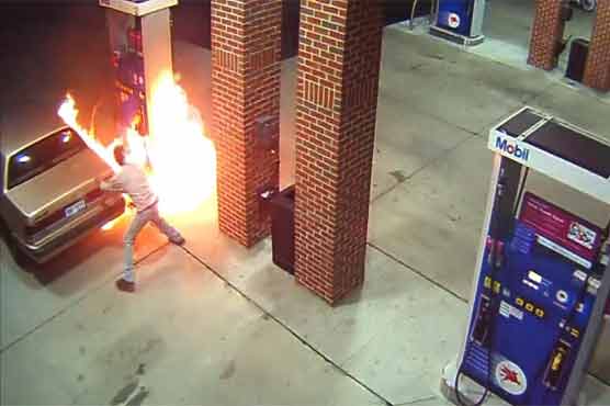 The man darts to safety and later uses a fire extinguisher to put out the flames