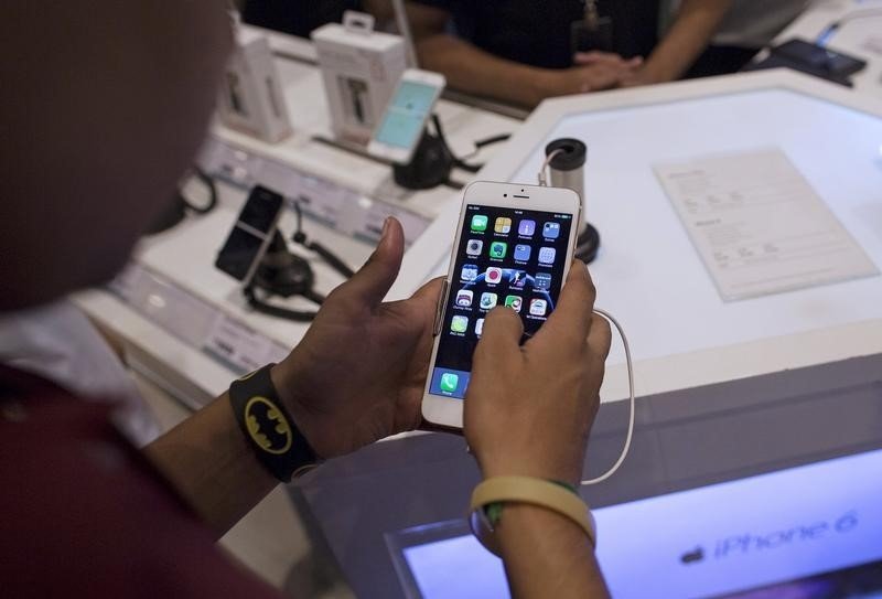 A man inspects the Apple iPhone 6 Plus at an electronics store in Mumbai India