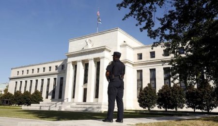 A Federal Reserve police officer keeps watch while posted outside the Federal Reserve headquarters in Washingt