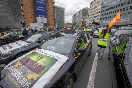 Taxi drivers from all over Europe line a street during a protest against online ride-sharing company Uber in central Brussels Belgium