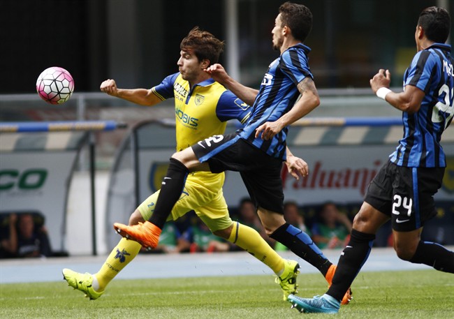 Chievo's Alberto Paloschi left is challenged by Inter Milan's Alexis Telles during a Serie A soccer match at Bentegodi stadium in Verona Italy Sunday Sept. 20 2015