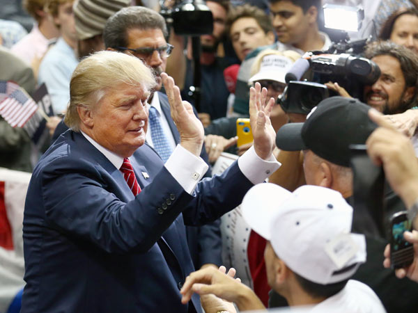 Republican presidential candidate Donald Trump greets supporters during a campaign rally at the American Airlines Center on Sept. 14 2015 in Dallas