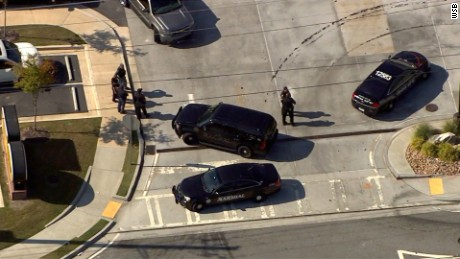 Two officers were chasing robbery suspects when the suspects crashed into a gas station in Tucker Georgia