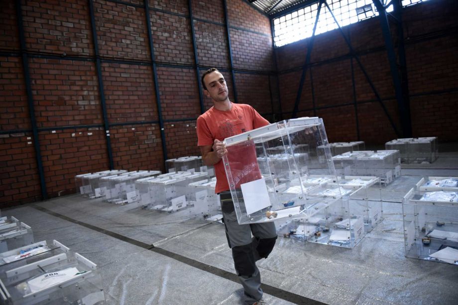 A municipality worker carries a ballot box at a warehouse in the northern Greek city of Thessaloniki Tuesday Sept. 15 2015. Leftwing Syriza party leader and former Prime Minister Alexis Tsipras called a snap election for Sunday Sept. 20 after reaching