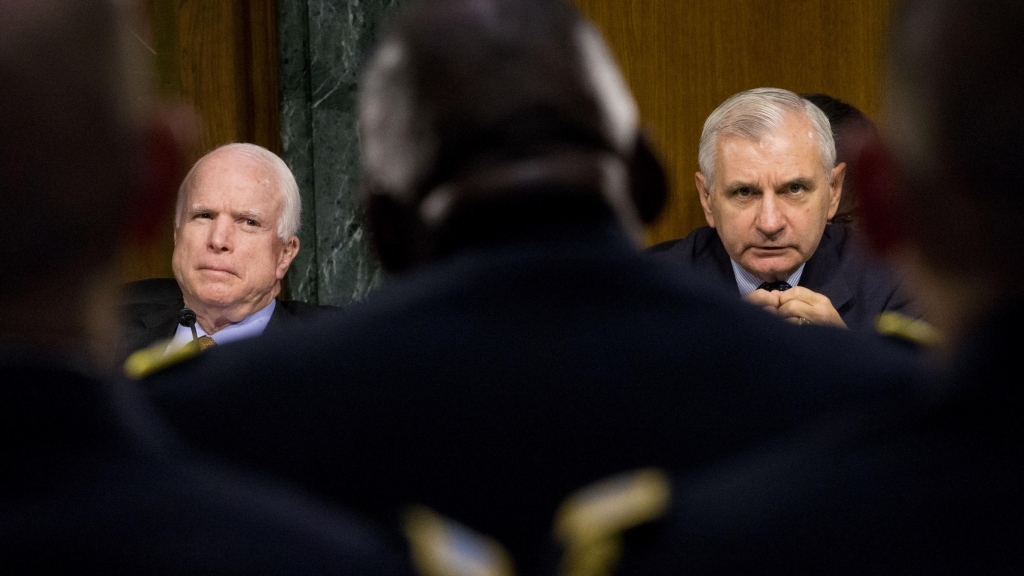 Sens. John McCain R-Ariz. left and Jack Reed D-R.I. right hear testimony on operations against ISIS from Gen. Lloyd Austin