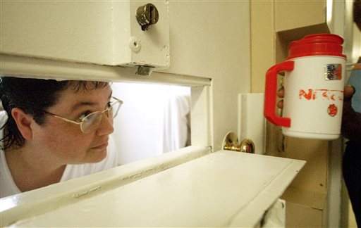 Kelly Renee Gissendaner the only woman on Georgia's death row looks through the slot in her cell door as a guard brings her a cup of ice at Metro State Prison in Atlanta. (Bita Honarvar  Atlanta Journal-Const