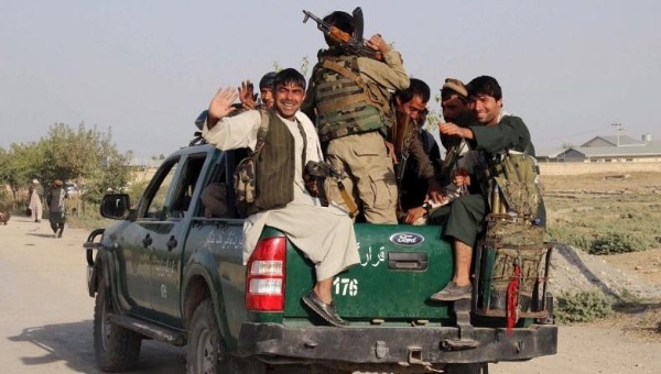 Afghan police sit at the back of a truck near a frontline during a battle with the Taliban in Kunduz city northern Afghanistan