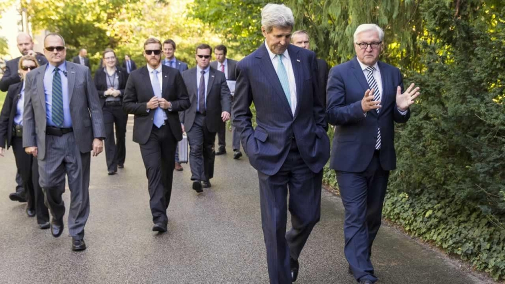 John Kerry walks with German Foreign Minister Frank Walter Steinmeier before a meeting with a group of Syrian Refugees at VillaBorsig Sunday Sept. 20 2015 in Berlin