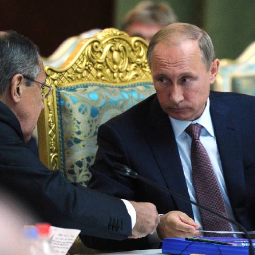 Vladimir Putin listens to Russia's Foreign Minister Sergey Lavrov left at the meeting of the Collective Security Treaty Organization in Dushanbe Tajikistan Tuesday Sept. 15 2015. Russian President Vladimir Putin