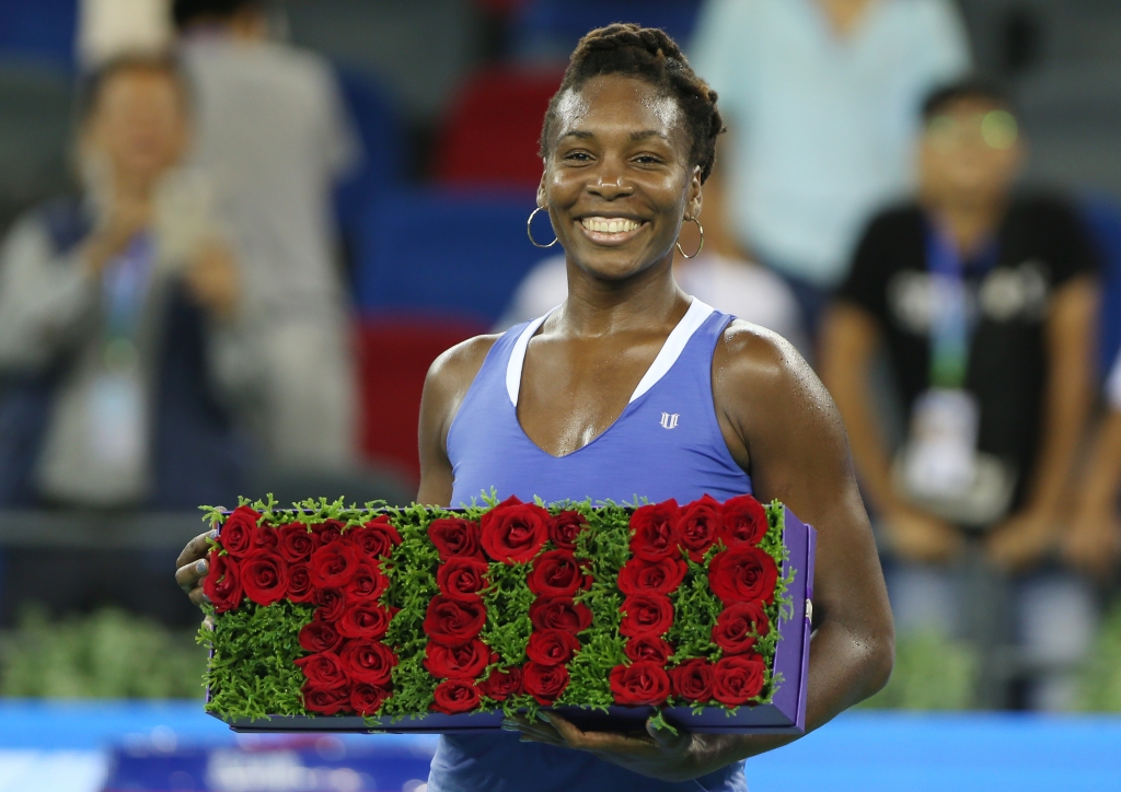 WUHAN CHINA- SEPTEMBER 29 Venus Williams of USA celebrates the 700 winning in her career after winning the match against Julia Goerges of Germany on Day Dongfeng Motor Wuhan Open at Optics Valley International Tennis Center