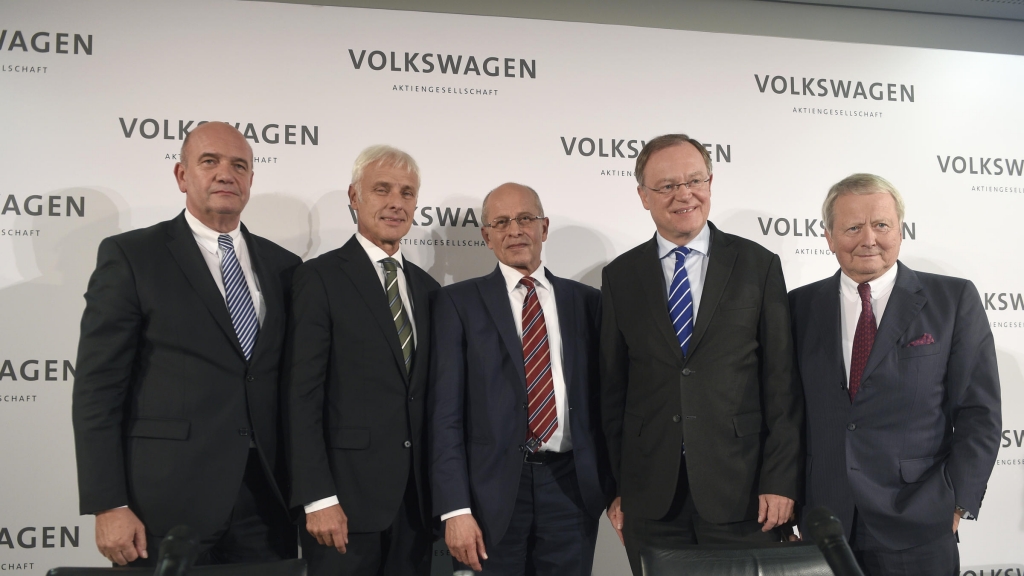 New Volkswagen CEO Matthias Mueller poses with Berthold Huber acting head of the Supervisory board of Volkswagen Stephan Weil Prime Minister of Lower Saxony and member of the Supervisory board Wolfgang Porsche (rig