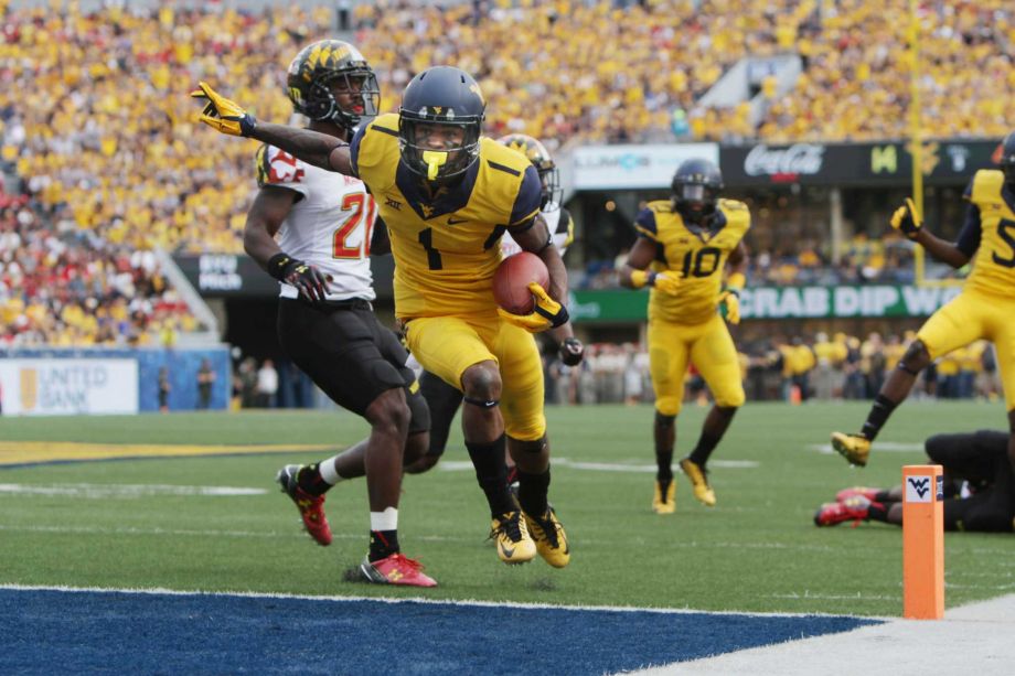 West Virginia wide receiver Shelton Gibson beats Maryland defensive back Sean Davis to the end zone during the first half of an NCAA college football game Saturday Sept. 26 2015 in Morgantown