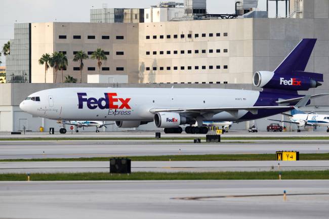 Fed Ex cargo jet taxis on the runway after landing at Miami International Airport in Miami