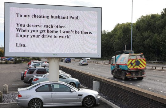 The wife known only as Lisa forked out hundreds of pounds for the giant 15ft x10ft message- so that husband Paul would see it on the way to work