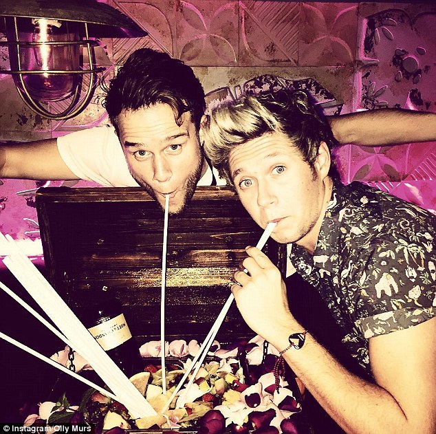 X Factor family Niall and Olly Murs sipped on one of the club's famous treasure chest cocktails as they partied the night away