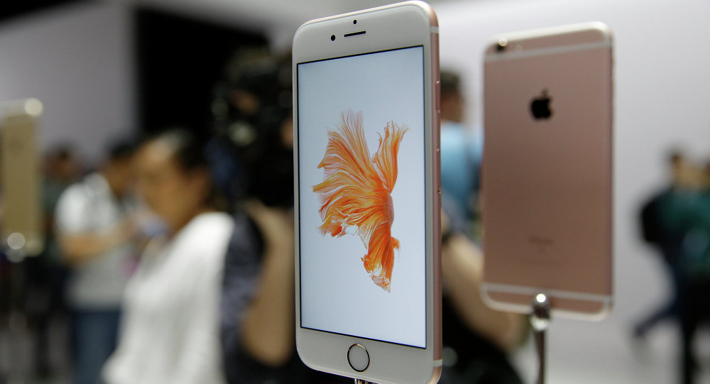 People look over the new Apple iPhone 6s models during a product display