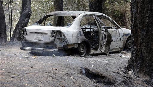 The charred remains of a car belonging to Leonard Neft who has been missing since a wildfire tore through the area and destroyed his home days earlier sits in the Anderson Springs area Wednesday Sept. 16 2015 near Middletown Calif. Aided by drought