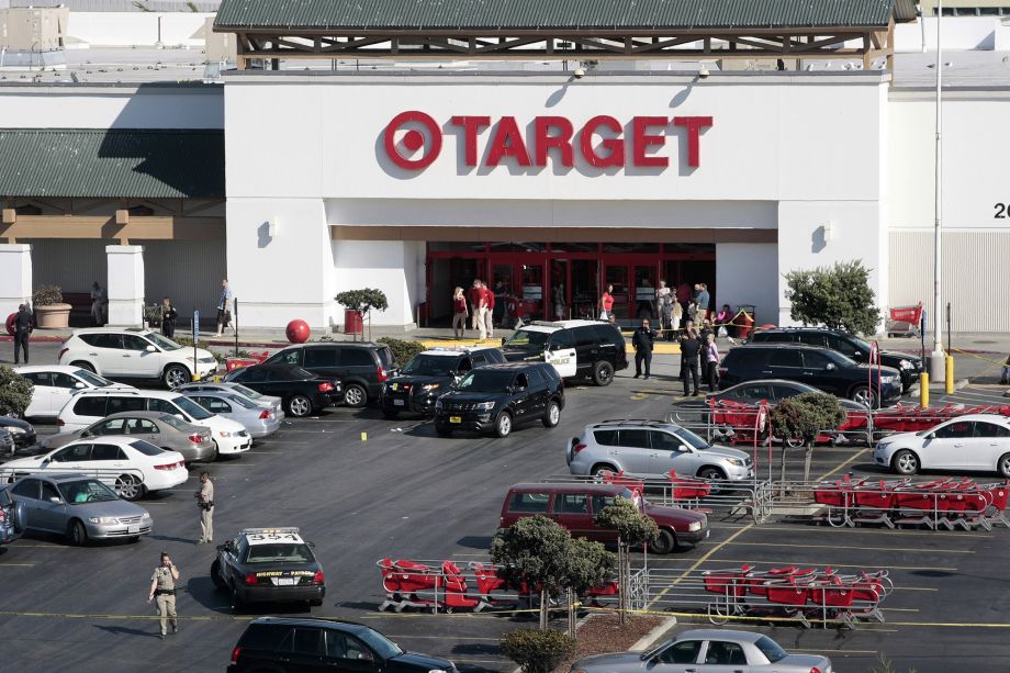 Police taped off a section of the parking lot of a Target store after a fatal shooting Monday Sept. 21 2015 in Sand City Calif. Monterey District Attorney Dean Flippo tells the Santa Cruz Sentinel officers were trying to serve a warrant to men sitting