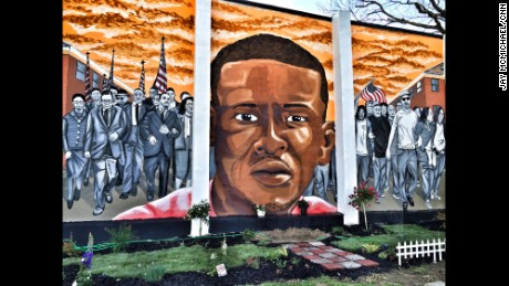 A Freddie Gray memorial mural seen on the side of a house across the street from where he was arrested