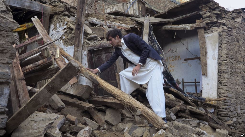 A Pakistani youth examines an earthquake-damaged house in Mingora the main town of Swat valley Oct. 27 2015