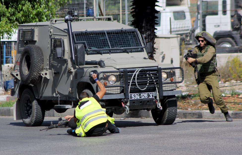 A Palestinian posing as a journalist stabing an Israeli soldier with a knife before being shot dead near the West Bank city of Hebron today