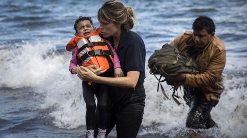 A Syrian child is rescued from a dinghy in Greece