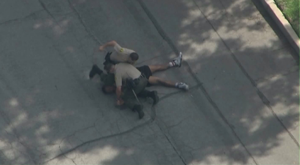 A deputy is seen punching a man at the end of pursuit in Pasadena on Oct. 15 2015