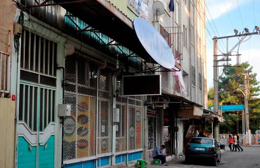 A man sits on a stool outside the closed Islam Tea Shop in Adiyaman Turkey