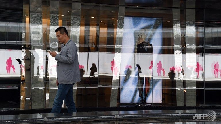 A man walks past stores in a shopping mall in Beijing on the second day of the National Day holidays on Oct 2 2015