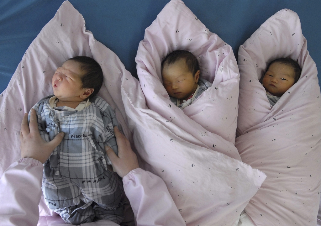 A nurse takes care of newborn infants at a hospital in Huai'an Jiangsu province in this