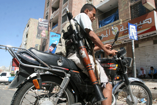 A pro-government fighter rides a motorbike in Yemen’s southwestern city of Taiz yesterday