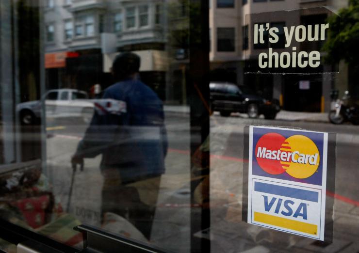 A sticker advertising Visa and Master Card credit cards hangs in a window in San Francisco California Feb. 25 2008.                    Justin Sullivan  Getty Images