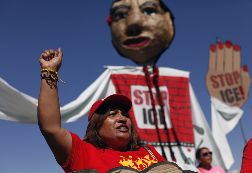 A woman at Hance Park clinches her fist as she protests Immigration and Customs Enforcement