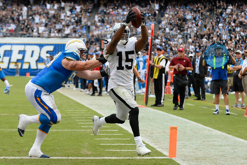 Oakland Raiders wide receiver Michael Crabtree scores a touchdown as San Diego Chargers nose tackle Sean Lissemore defends during the second half of an NFL football game Sunday Oct. 25 2015 in San Diego