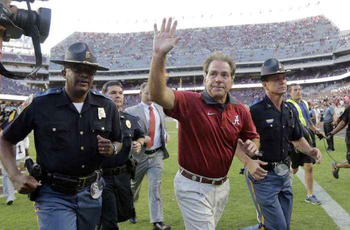 Alabama coach Nick Saban waves to fans as he runs off the field following the Crimson Tide's victory over Texas A&M in College Station. AP