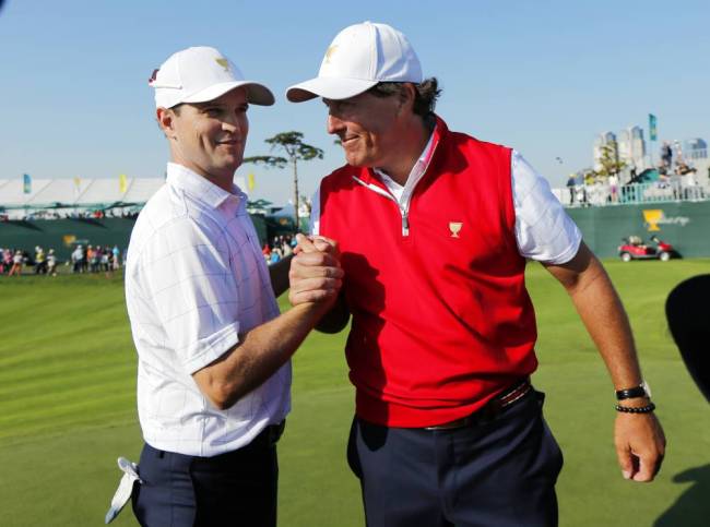 Zach Johnson left and Phil Mickelson shaking hands after they won their foursome match at the Presidents Cup