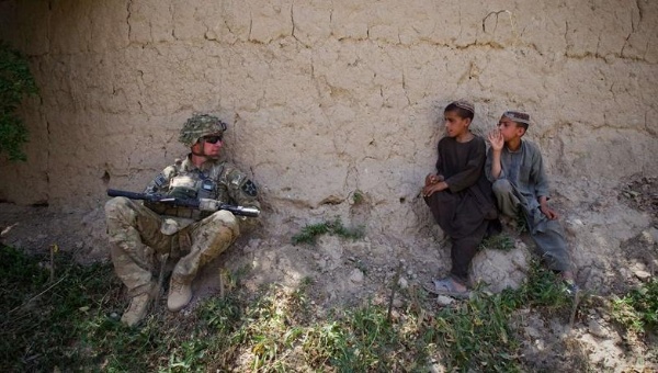 Afghan boys look at a U.S. Army soldier of 5-20 Infantry Regiment attached to the 82nd Airborne Division