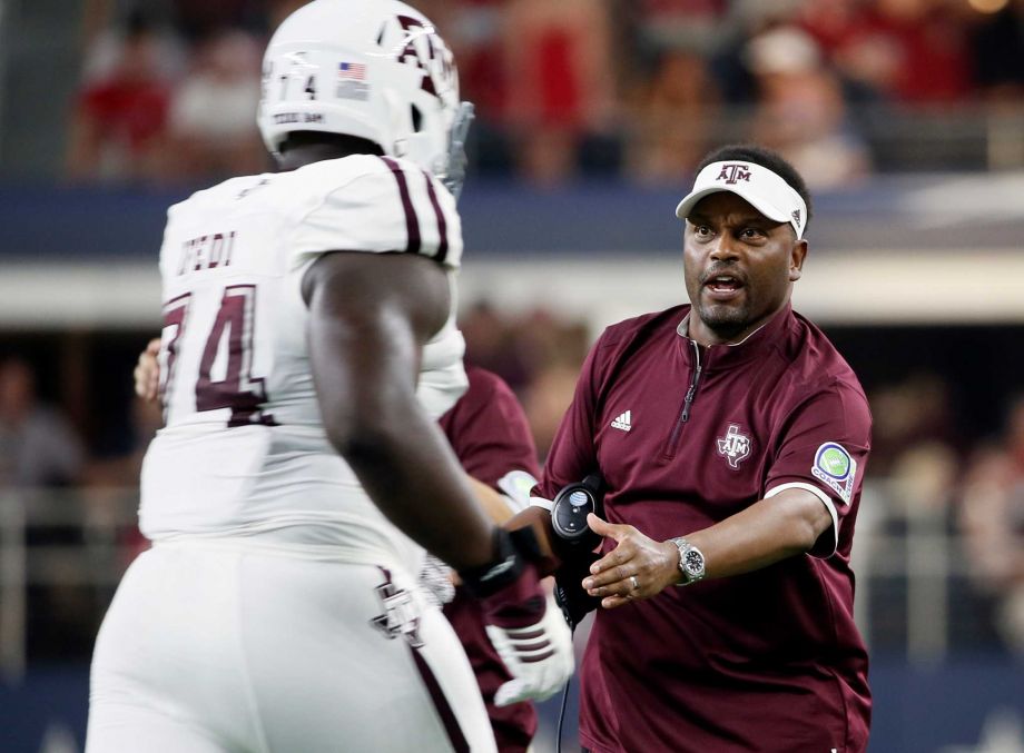 Texas A&M offensive lineman Germain Ifedi is greeted by coach Kevin Sumlin as he jogs off the field during the first half of an NCAA college football game against Arkansas on Saturday Sept. 26 2015 in Arlington Texas. Ph