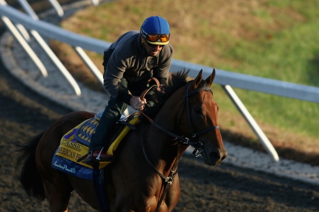 Exercise rider Georgie Alvarez takes Triple Crown winner American Pharoah over the track in preparation for the Breeders Cup Classic at Keeneland Racecours