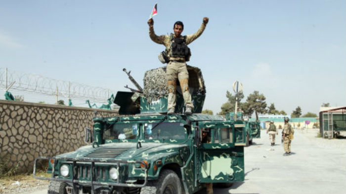 An Afghan soldier raises his hands as a victory sign after forces retook the strategic northern city of Kunduz- Dehsabzi  AP