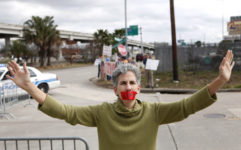 An opponent of Planned Parenthood demonstrates in front of a new facility in Houston in January