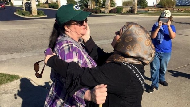 Cynthia De Boutinkhar embraces an anti Islam protester outside the Noor Islamic Cultural Center in Columbus Ohio