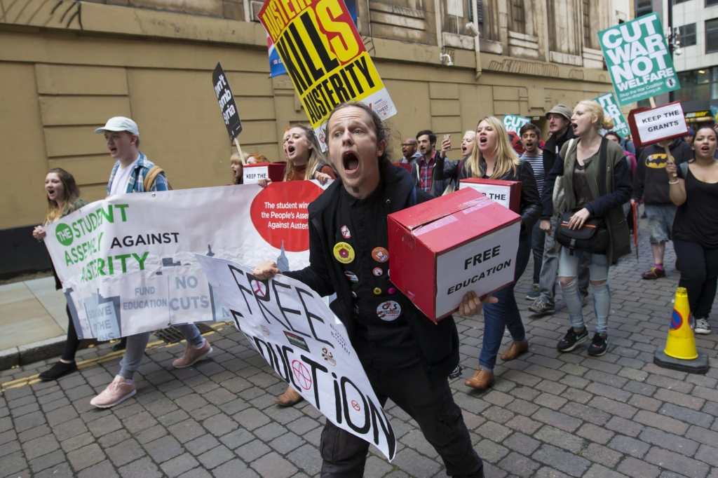 Anti-austerity protestors demonstrate outside Britain's Conservative Party Conference Manchester