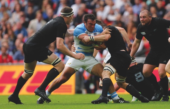 Argentina’s captain Agustin Creevy centre is tackled by the New Zealand defence