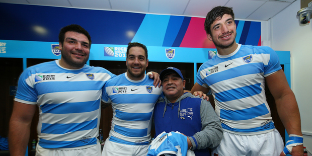 Diego Maradona poses with Ramiro Herrera Horacio Agulla and Tomas Lavanini of Argentina in the dressing room after their win over Tonga