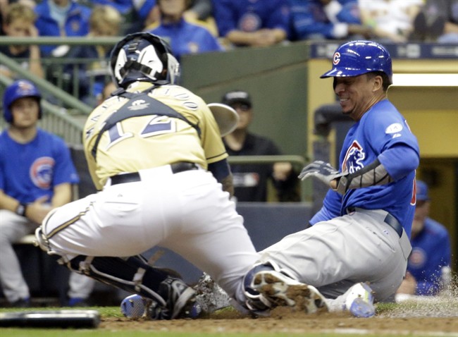 Chicago Cubs Quintin Berry is tagged out at home by Milwaukee Brewers catcher Martin Maldonado during the eighth inning of a baseball game Sunday Oct. 4 2015 in Milwaukee. Berry tried to score from third on a ball hit by Starlin Castro. (AP