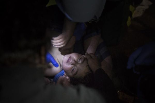 Paramedics and doctors try to revive a baby