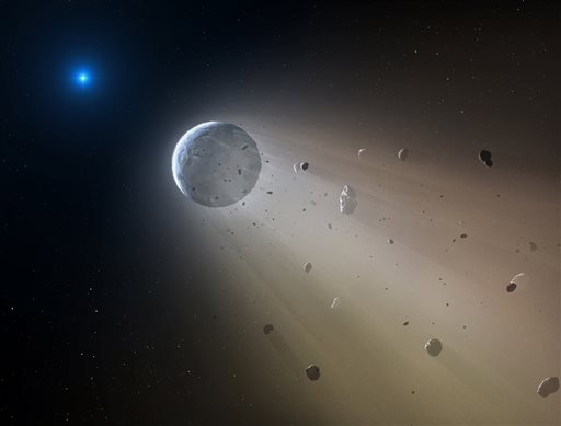 This artist's rendering provided by the Harvard Smithsonian Center for Astrophysics shows an asteroid slowly disintegrating as it orbits a white dwarf star. On Wednesday Oct. 21 2015 researchers at the Harvard Smithsonian Center for Astrophysics